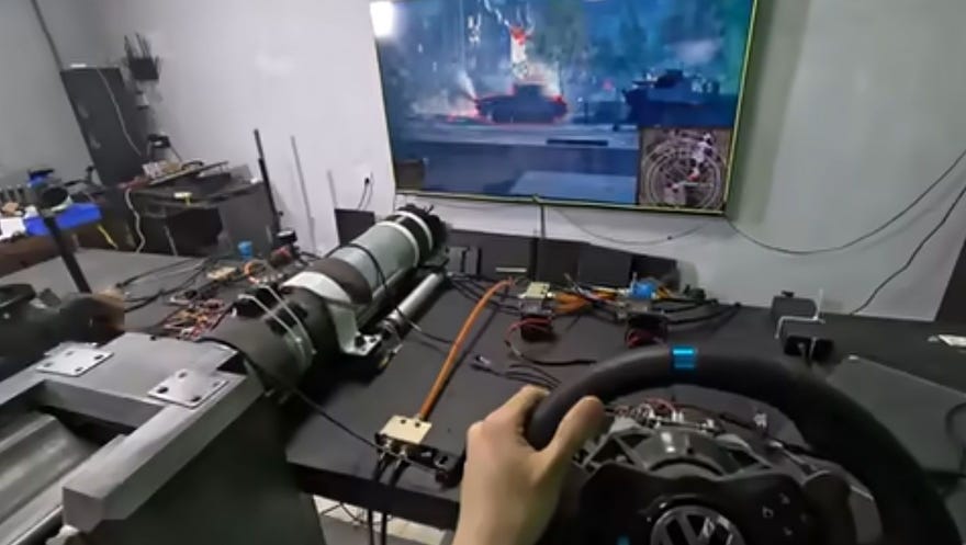 An engineer pilots a homemade tank simulator controller with World of Tanks.